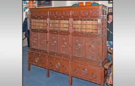 A Rare Aesthetic Movement Highly Carved Cabinet Cupboard In Oak. The top has three leaded top doors