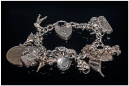 Silver Charm Bracelet Loaded With 17 Charms, Complete With Padlock Fastener, Weight 62 Grams