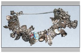 Vintage Silver Charm Bracelet, loaded with numerous charms in various subjects; 102.2 grams