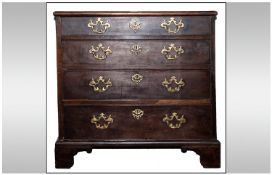 George III Walnut Chest Of Small Size And Proportions. With original brass fretwork drop handles in