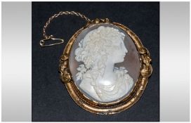 Victorian Ornate Pinchbeck Framed Large Cameo features a portrait of a classical young woman. 2.5``