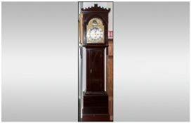 A Scottish Grandfather Clock in a stained pine case. With an arched brass dial. Fully engraved with