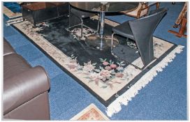 Chinese Oriental Style Woolen Rug, black ground with floral decoration & border.