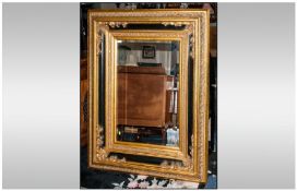 Large Reproduction Black Lacquered and Gilt Wall Mirror of Impressive size with floral moulded