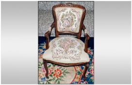 A Reproduction Mahogany French Style Open Arm Chair with tapestry to arms, back & seat. On carved