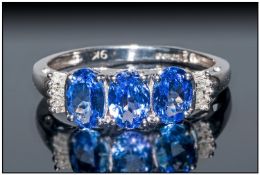 Tanzanite and Diamond Ring, three oval cut bright blue tanzanites with hints of purple, set with a