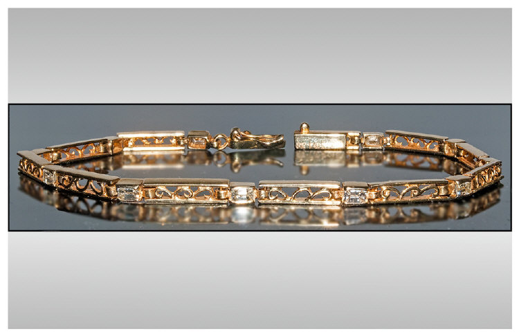 18ct Gold And Diamond Bracelet set with 11 step cut diamonds of good colour. Estimated diamond