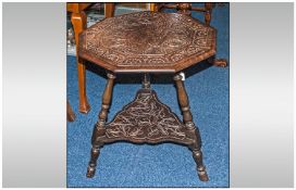 Carved Oak Occasional table with shelf below, on a tripod base.