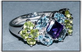 Amethyst, Topaz and Peridot Ring, a square cut amethyst flanked by four blue topaz with bright