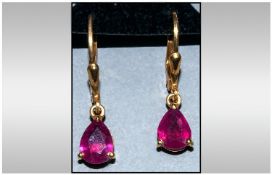 Ruby Lever Back Earrings, pear cut solitaire rubies, each of 1.25cts, suspended from 14ct yellow
