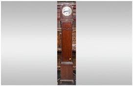 Oak Cased Grandmother Clock With A Round Steel Dial with a single winding aperture. The case with
