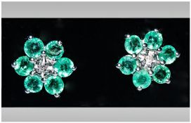 Emerald and Diamond Cluster Earrings, each earring comprising six round cut emeralds surrounding a