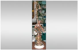 Bronzed Resin Lamp depicting a semi clad lady with a vine leaf. Single branch. 25`` in height.