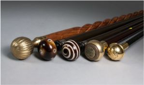 Five Reproduction Ball Pommel Walking Sticks with ebony and teak shafts, 3 with brass tops, 2 with