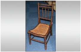 Beech Wood Bobbin Back Chair late Victorian with a wicker seat.