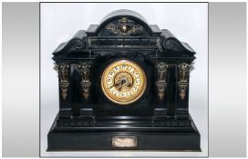 A Large Black Belgian Slate Mantle Clock with an enamel dial and fancy gilt filigree face. With