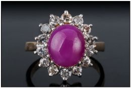 A 1930`s Cabochon Cut Star Ruby and Diamond Cluster Ring. The Central Star Ruby Surrounded By 16