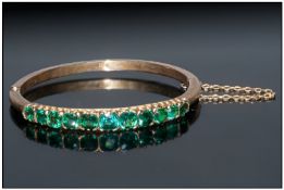 Late 19th/Early 20thC Gemset Hinged Bangle, The Front Mounted With 11 Green Faceted Stones In A