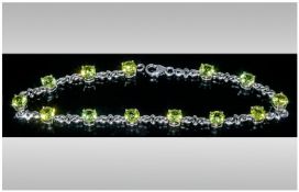 Peridot Line Bracelet, round cut, bright green peridots, totalling 7cts, interspersed with platinum