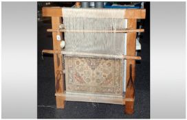 A Persian Miniature Loom Showing A Segment Of Handmade Carpet, attached to the wooden frame are