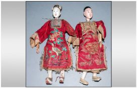 Pair of Chinese Wood and Gesso Dolls, lady and gentleman of wealth; each with roughly carved wooden