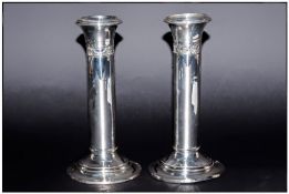 Edwardian Pair Of Silver Candlesticks in the art nouveau style. Raised on circular stepped bases.