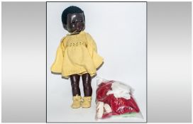 Black Pedigree Doll, composition body, moving eyes and moveable joints. Together with a small