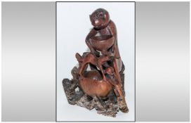 Chinese Humorous 19th Century Soapstone Figure Group depicting a large monkey sitting and holding a