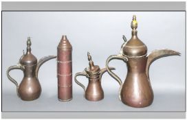 A Set Of Three Antique Arabian Brass Coffee Pots, of traditional form with shaped spouts, curved