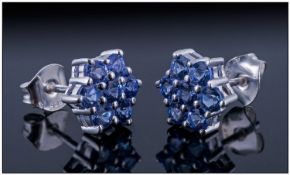 Tanzanite Cluster Earrings, each a cluster of seven round cut tanzanites in a flower or star shape,