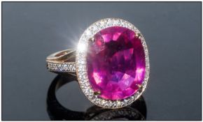 18ct Gold Ruby & Diamond Cluster Ring the single stone oval faceted ruby within a brilliant cut