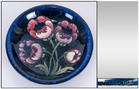 William Moorcroft Signed Shallow Bowl `Big Poppy` Design on blue ground. Circa 1920`s. 7.25`` in