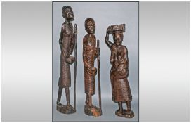 Three Large Carved Ebony Type African Figures depicting natives. Two men walking with bowls &