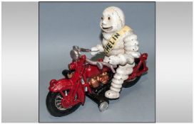 Novelty Cast Iron Style Advertising Mascot in the Form of the `Michelin Man` riding a Motorbike.