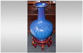 A Large Modern Chinese Flambe Glazed Fish Tail Vase, blue/turquoise colour on a 5 legged wooden