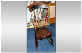 A Lancashire Nineteenth Century Splatback Rocking Chair in elm and beech wood with a shaped back