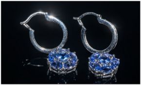 Tanzanite Cluster Drop and Hoop Earrings, each cluster comprising five oval cut tanzanites