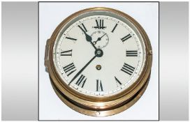 A Ships Brass Circular Wall Clock. 7 x 7 Inches.