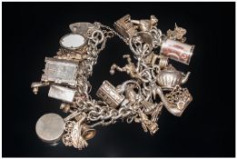 A Vintage Good Quality Silver Bracelet loaded with 25 charms. All fully marked silver. Some