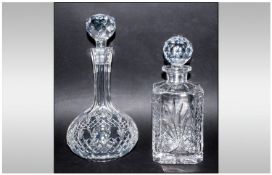 Two Cut Glass Decanters with faceted stoppers and star bases. 10 and 12 inches in height.