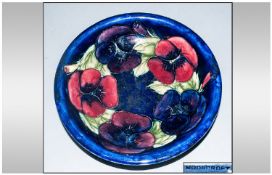 W Moorcroft Signed Bowl `Pansy` pattern on blue ground. c 1920. 7.25 inches diameter.
