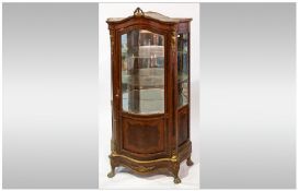 Louis XVI Style Vitrine of serpentine shape front & sides. With a single glazed door, exposing a