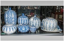 Collection of Blue and White Pottery comprising 9 jars and covers (one with lid missing) largest