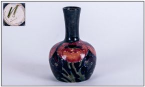 William Moorcroft Miniature Vase, Big Poppy pattern on blue ground. Height 3.75 inches.