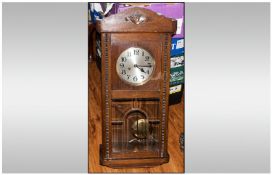 A German Oak Box Clock, with round steel dial, with bevelled glass segmented, exposed doors, 29``