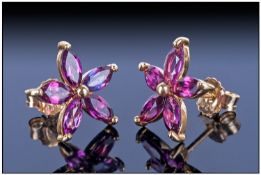 Rhodolite Garnet Floral Stud Earrings, each earring having five marquise cut garnets forming an