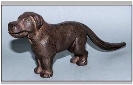 English Novelty Cast Iron Nut Cracker in the form of a long tailed dog. 4`` in height.