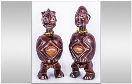 A Pair of Yoruba Fertility Figures depicting male and female tribe members adorned with beads