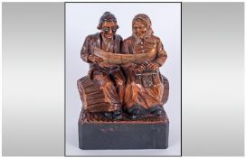 Black Forest Fine Hand Carved Wooden Figure Of An Old Couple Sitting On A Log Reading. 9" in