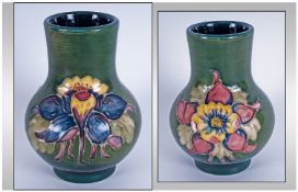 Moorcroft Small Vase, 'Orchids' pattern on green ground. 4.25" in height.